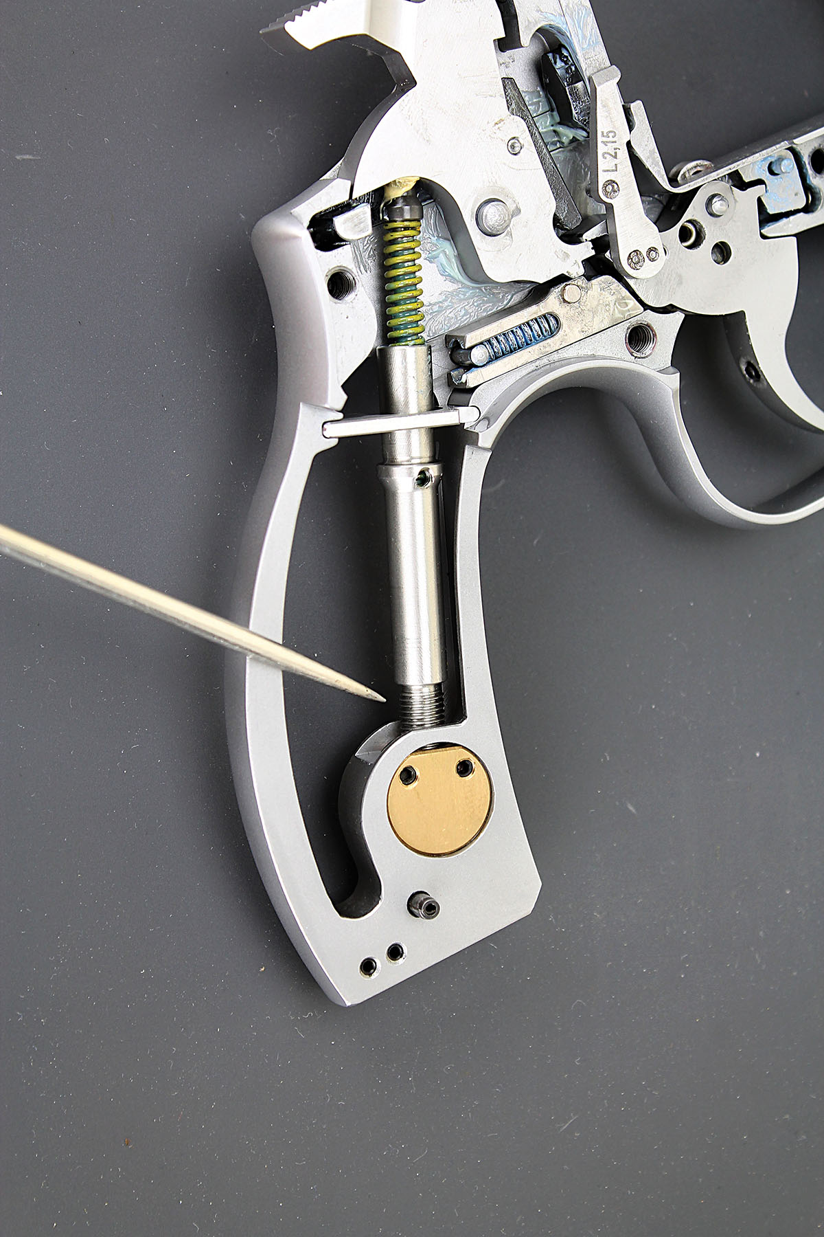 The mainspring and strut enter a hollow tubular screw that threads onto a flat, cylindrical seat, permitting very precise adjustment.